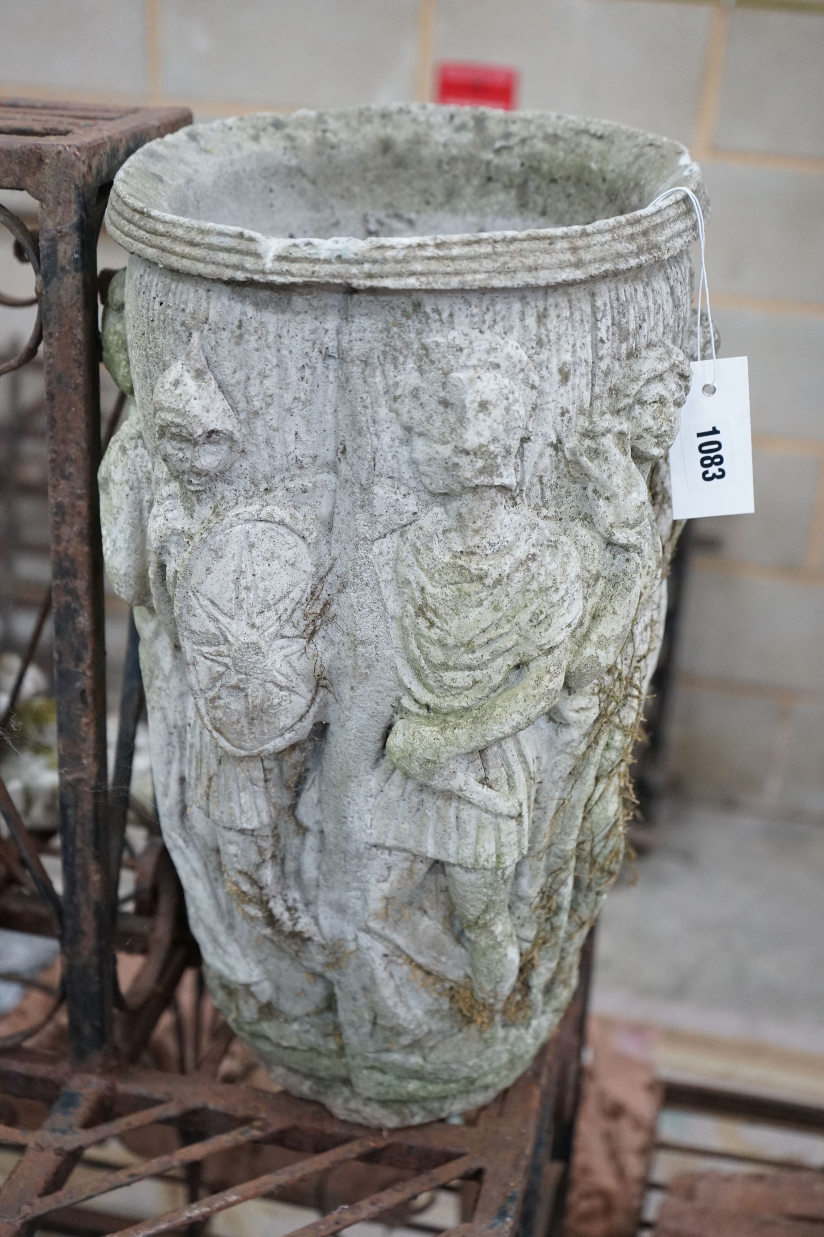 An oval reconstituted stone garden planter moulded with classical figures, height 47cm